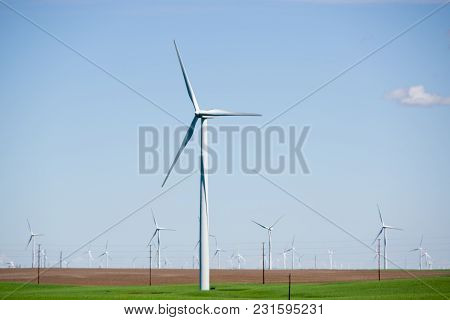 Wind Powered Electricity Generators Sitting In A Field. Located In Eastern Oregon.