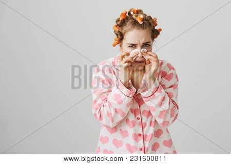 Funny Woman At Home With Hair-curlers, Wearing Pyjamas With Heart Template. Holding Cotton Pads On N