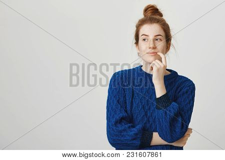 Woman Has Great Plan In Mind. Indoor Shot Of Pretty Woman With Red Hair And Freckles In Winter Sweat