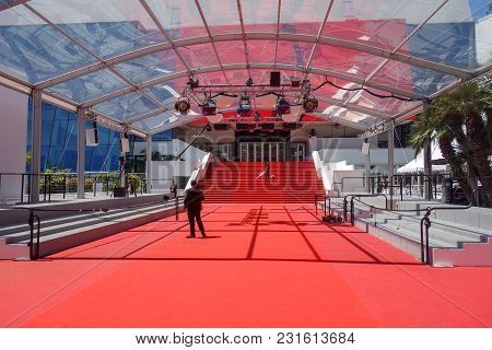 Cannes, France -- May 19, 2017: A Man Vacuums The Iconic Red Carpet Steps Ahead Of Festivities At Th