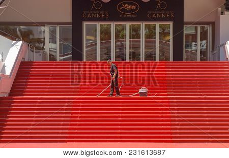 Cannes, France -- May 19, 2017: A Man Vacuums The Iconic Red Carpet Steps Ahead Of Festivities At Th