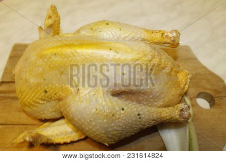 homemade stuffed capon on wooden cutting board