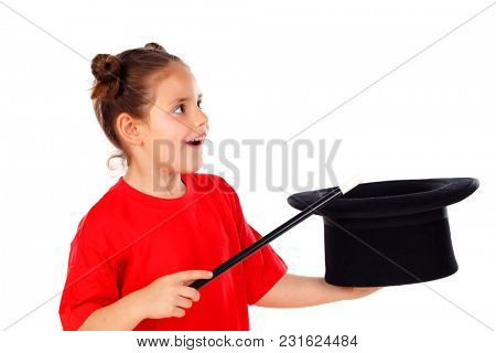 Pretty little girl doing magic with a top hat and a magic wand isolated on a white background