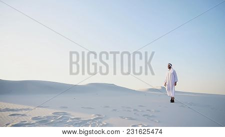 Handsome Young Muslim Driving Along Bottomless Desert And Looking Toward Sunset, Admiring Beauty Of 