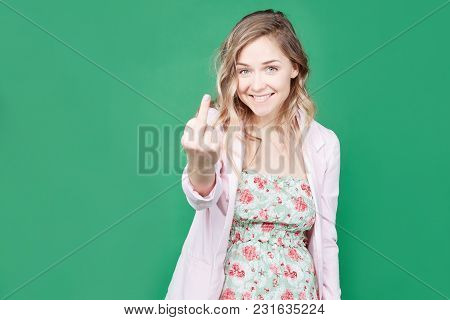 Fuck You. Happy Woman With Long Hair, Cheerful Expression, Shows Middle Finger, Has Fun Indoor, Gest