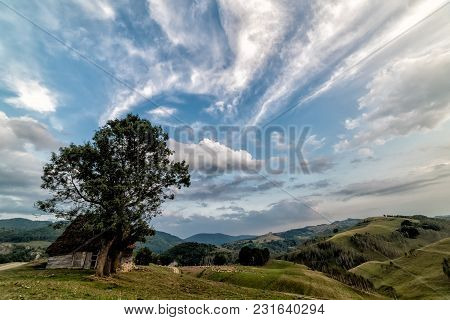 Beautiful Mountain Landscape With And Old House, Trees And A Cloudy Morning Sky, Dumesti, Salciua, A