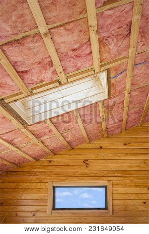 Fibreglass Insulation Installed In The Sloping Ceiling Of A Timber House.