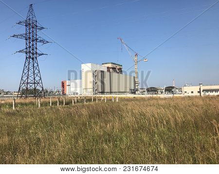 Nuclear Power Plant Located In The Town Of Desnogorsk. In The Foreground Is Dry Autumn Grass, In The