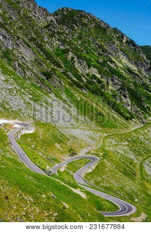 Serpentine Road In Fagarasan Mountains. Lovely Transportation Background. Popular Tourist Destinatio