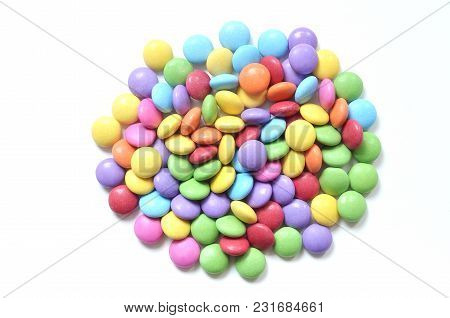 Isolated Heap Of Colored Smarties On White Background