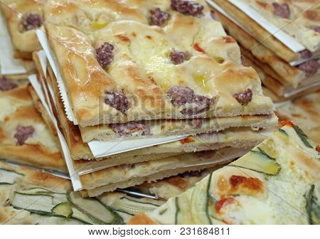 Bread With Sausace And Slices Of Pizza For Sale In The Stall Of Street Food