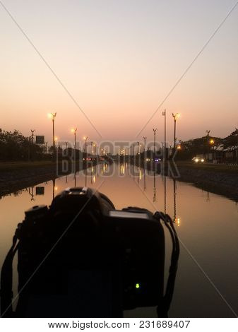 Dslr Camera Shooting On A Cityscape Sunset With Sea Reflection At Utthayan Access Road, Khet Thawi W