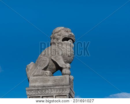 Stone Buddhist Lion Guard Shi-dza In The Paw Holds A Ball, Symbolizing Buddhist Knowledge, Bringing 