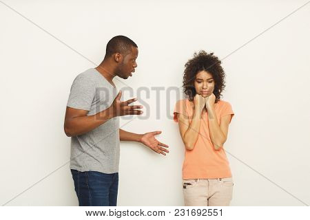Black Couple Arguing. Angry African-american Men Shouting At His Girlfriend At White Studio Backgrou