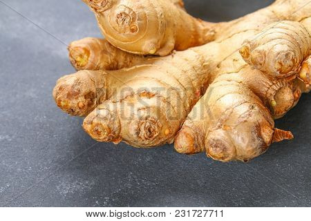 Spicy Root Of Ginger On A Wooden Table