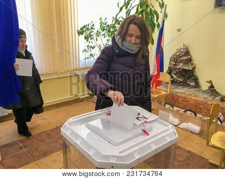 Moscow, Russia - March 18, 2018: The Voter Puts The Ballot In The Box In The Elections  Of President