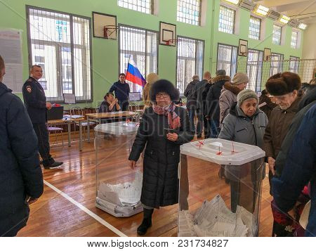 Moscow, Russia - March 18, 2018: The Voter Puts The Ballot In The Box In The Elections  Of President