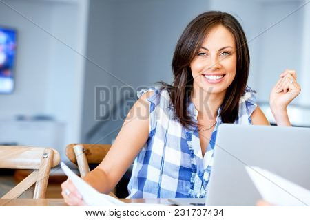 Woman with papers in their living room