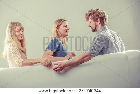 Betrayal And Infidelity Concept. Handsome Boy With Two Attractive Blondie Girls. Man Cheating Women 