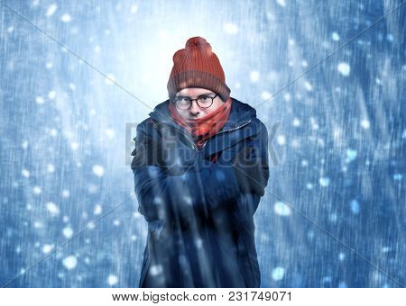 Handsome young boy shivering and trembling at snowstorm concept