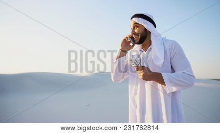 Arab Young Sheikh Calls To Friend Or Business Partner And With Smile On Face And Joy In Eyes Tells A