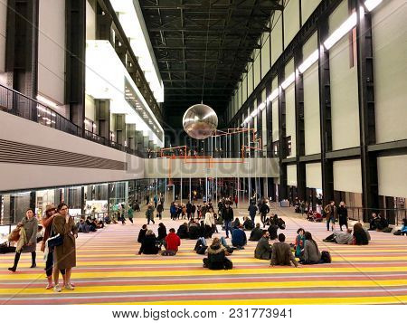 LONDON - MARCH 16, 2018: Visitors interact with the 'One Two Three Swing!' exhibtion by Danish artistsâ collective SUPERFLEX inside the Turbine Hall of Tate Modern art gallery in Bankside, London, UK.