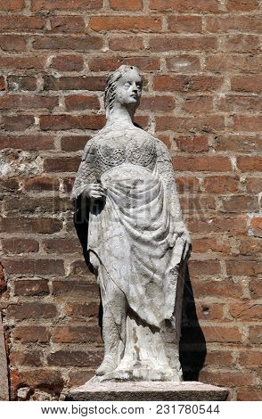 VERONA, ITALY - MAY 27: Female statue on the portal of Saint Eufemia Gothic-style, Roman Catholic church in Verona, Italy, on May 27, 2017.