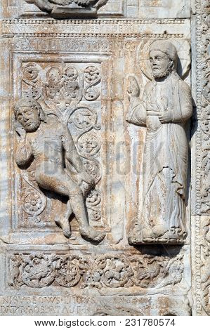 VERONA, ITALY - MAY 27: Creation of Adam, medieval relief on the facade of Basilica of San Zeno in Verona, Italy, on May 27, 2017.