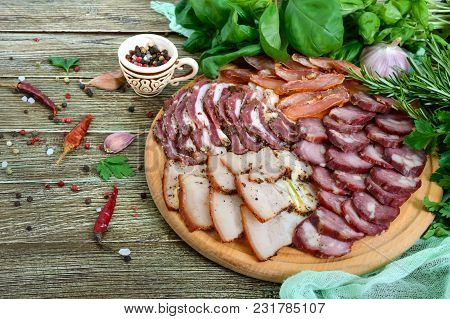 Big Meat Set. Homemade Smoked Pork-beef Sausage, Salted Bacon, Basturma Chopped Slices On A Wooden B