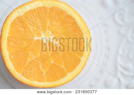 Big Fresh Juicy Round Citrus Orange Cut In Half With Unusual Form Pulp To The Top On White Patterned