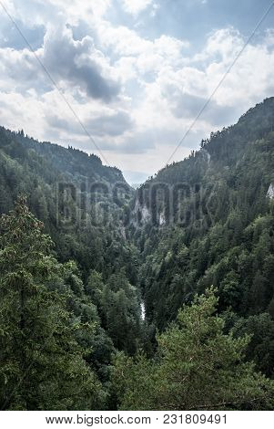 Wild Kvacianska Dolina Valley With Deep Forest, Limestone Rocks And Creek In Chocske Vrchy Mountains