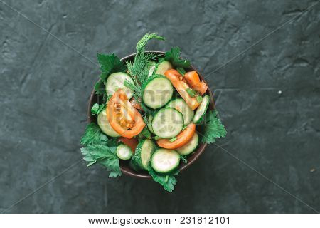 Fresh Salad With Vegetables On A Black Matte Background. The Concept Of A Healthy Diet.