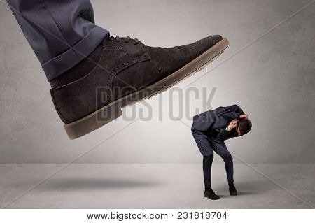 Young businessman illustrated inconsiderable by being trampled