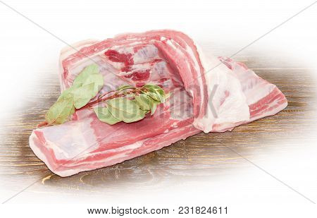 Two Strips Of The Pork From Side Part With Belly And Spare Ribs And Branch With Dry Laurel Leaves On