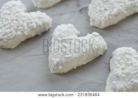 Sweet Crunchy Coconat Heart-shaped Biscuits Arranged In Pattern On Light Textured Background, Top Vi