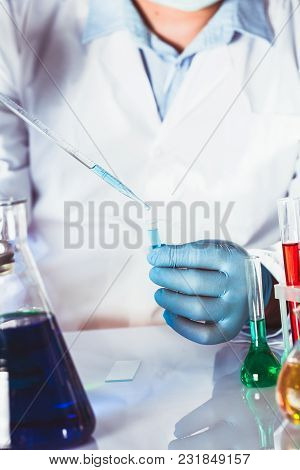 Scientist Holds Eppendorf Tube And Pipette. Focus On Test Tube
