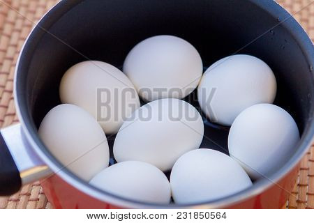 A Few Boiled Eggs In A Saucepan On Table