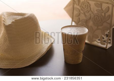A Glass Of Coffee On A Table In A Cafe With A White Hat And White Napkins