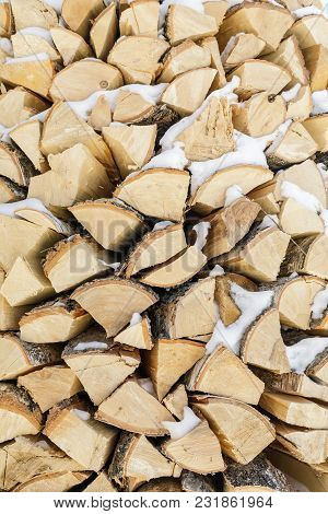 Firewood In Woodpile. Wooden Background.