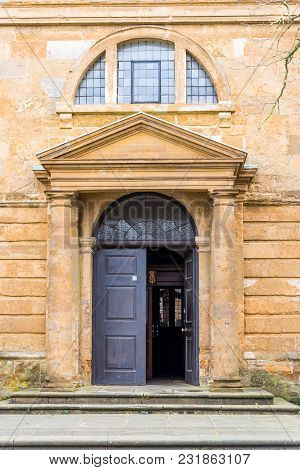 Day View Of Entrance Door To Holy Cross Church In Daventry Town Centre.