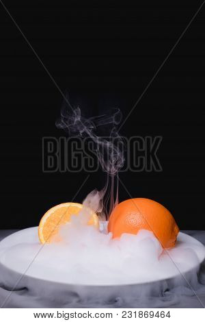 Fresh Frozen Fruit In Ice. Black Background
