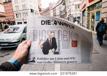 Paris, France - Mar 19, 2017: Man Reading Buying German Die Welt Newspaper At Press Kiosk Featuring 