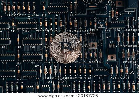Printed Circuit Board With A Chip And Resistance And A Bitcoin. The Concept Of The Mining Of Crypto-