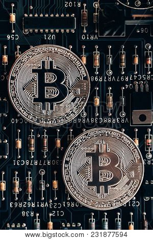 Printed Circuit Board With A Chip And Resistance And A Bitcoin. The Concept Of The Mining Of Crypto-