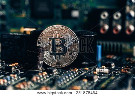 Printed Circuit Board With A Chip And Resistance And A Bitcoin. The Concept Of The Mining Of Crypto-