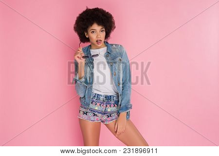 Be In Trend! Attractive Graceful Audacious Young Woman With Sunglasses Posing At The Camera In Studi