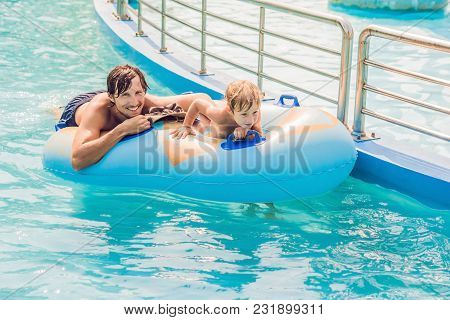 Father And Son Have Fun At The Water Park.