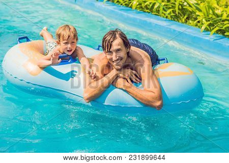 Father And Son Have Fun At The Water Park.