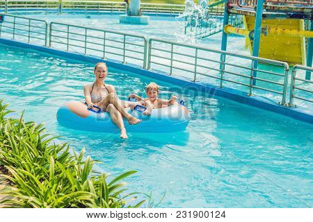 Mom And Son Have Fun At The Water Park.