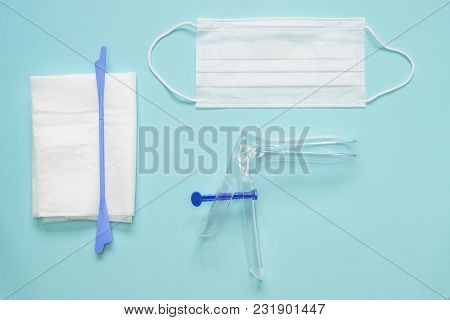 An Overhead Photo Of The Vaginal Speculum, Napkin, Health Mask And Spatula. The Medical Tools For Ho
